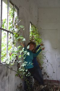 Danseuse adossée au mur d'une pièce en ruine envahie par le lierre — Hors Sol